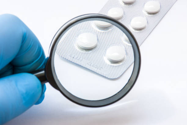 Testing, verification and determining pharmaceutical counterfeiting or fakes of medicines and medicinal substance quality concept. Pharmaceutical expert from checks number of medicine compliance