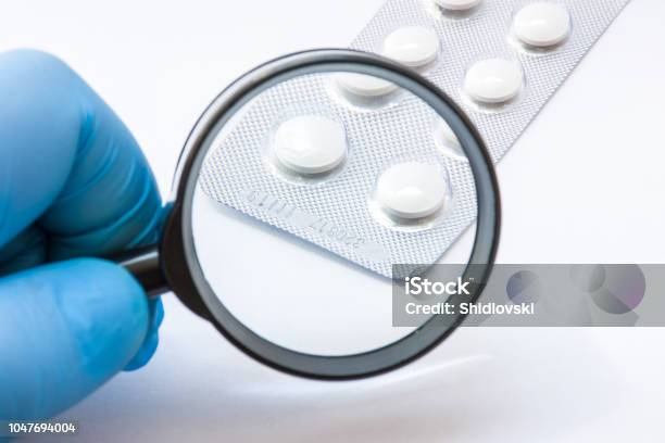 Testing Verification And Determining Pharmaceutical Counterfeiting Or Fakes Of Medicines And Medicinal Substance Quality Concept Pharmaceutical Expert From Checks Number Of Medicine Compliance Stock Photo - Download Image Now