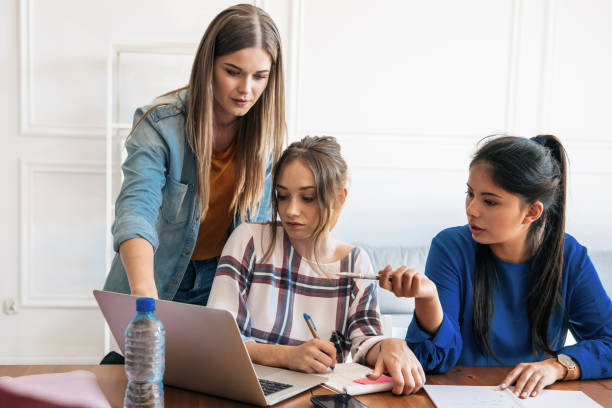 istock three young woman discussing on laptop 1047696324