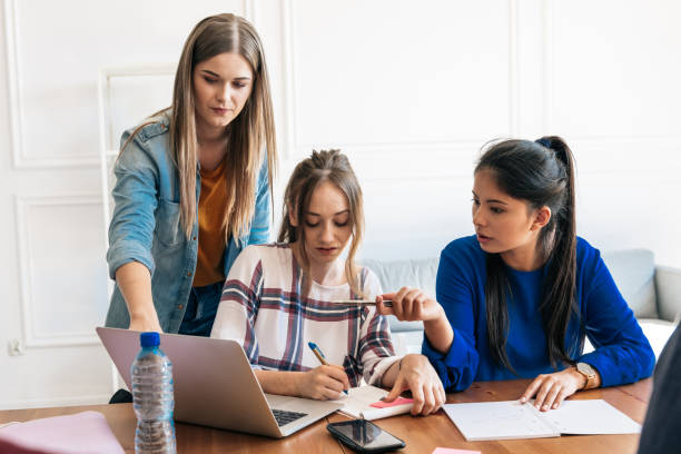istock three young woman discussing on laptop 1047699002