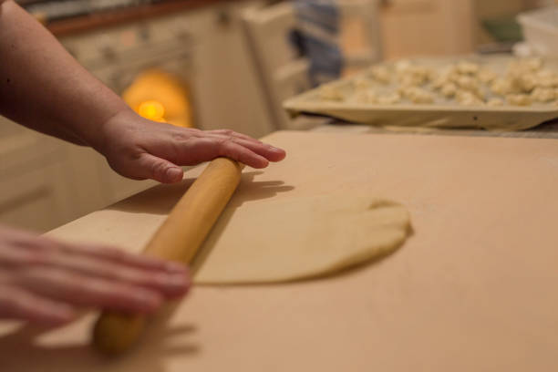 istock horizontal image of woman's hands stretching and working pizza dough 1047702740