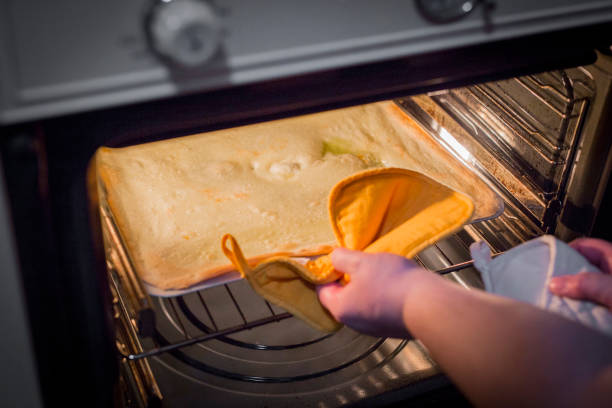 istock horizontal image of homemade pizzas while baking in the oven 1047702798