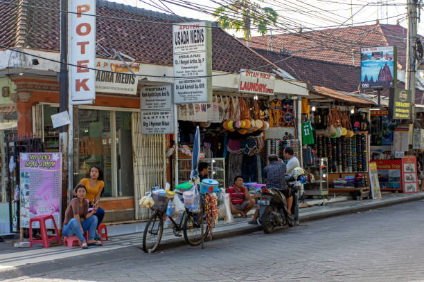 Street view of Legian in Kuta Kuta, Indonesia - September 14, 2018: Vendor waiting for customer at Legian street. Legian is famous among tourist for nightclub and entertainment. indonesian culture stock pictures, royalty-free photos & images