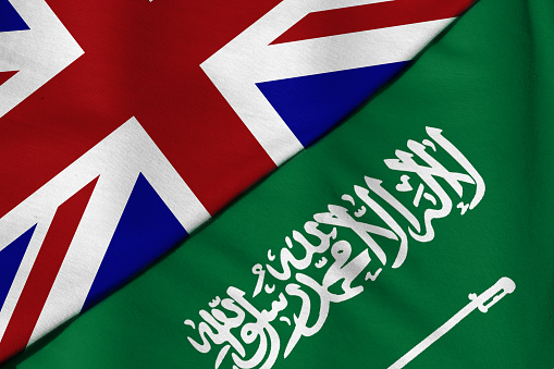 Two flags. United Kingdom and Saudi Arabia.