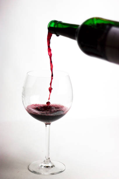 istock Pouring red wine into the glass 1047708224