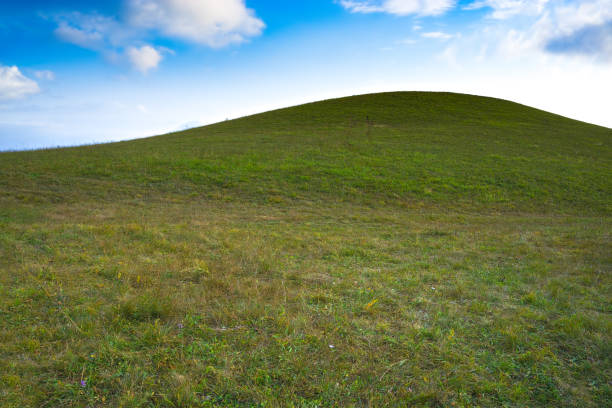 istock Green hill and blue sky 1047710648