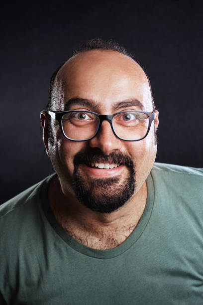 istock Bald man with eyeglasses looking into camera and smiling 1047711980