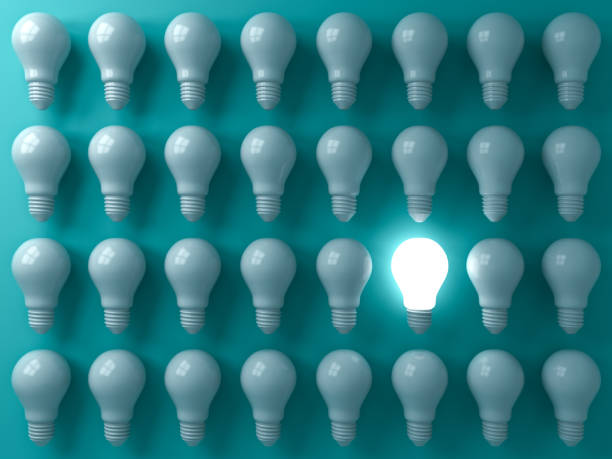 One glowing light bulb standing out from the unlit or dim bulbs on dark green pastel color background individuality and think different the business creative idea concepts 3D rendering One glowing light bulb standing out from the unlit or dim bulbs on dark green pastel color background individuality and think different the business creative idea concepts 3D rendering self coloured stock pictures, royalty-free photos & images