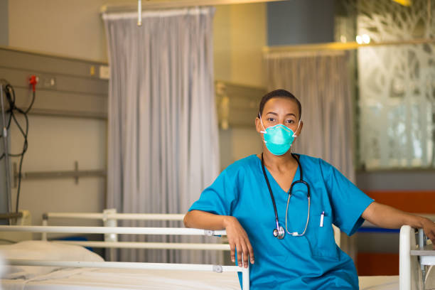 istock Front line healthcare worker wearing a protective mask 1047719836