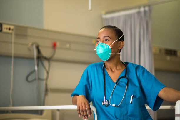 istock Front line healthcare worker wearing a protective mask 1047719886