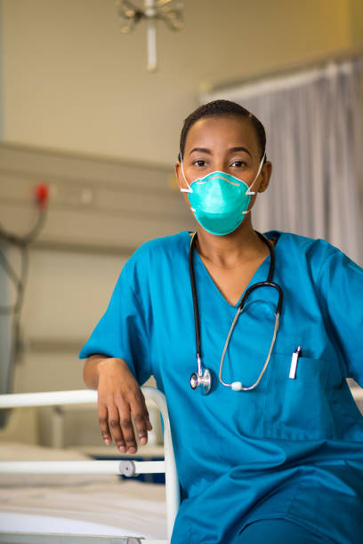 istock Front line healthcare worker wearing a protective mask 1047719890