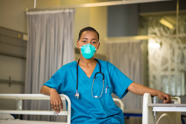 istock Front line healthcare worker wearing a protective mask 1047724356