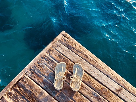 Slippers on the pier at sunset