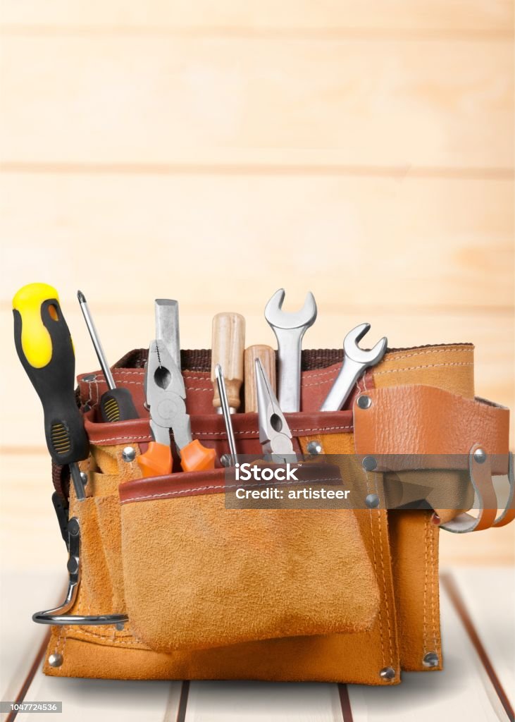 Hammer. Tool belt with tools on wooden desk Tool Belt Stock Photo