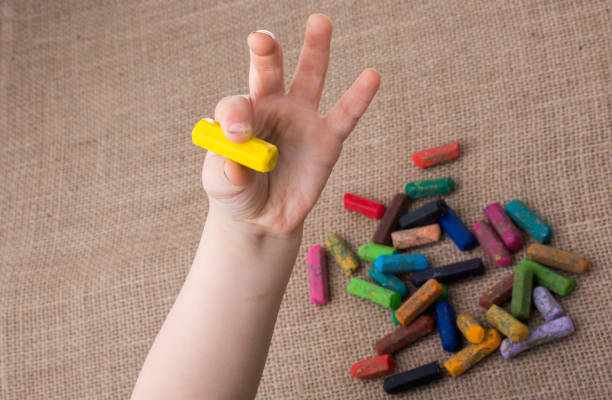 istock Used  color crayons and a toddlers hand 1047725218