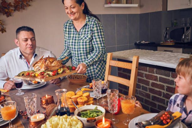 istock Family Having Traditional Holiday Stuffed Turkey Dinner 1047727814