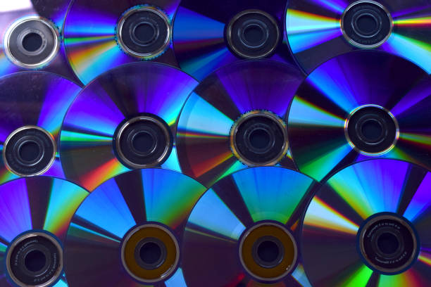 istock Background of illuminated DVD discs and CDs. 1047728064