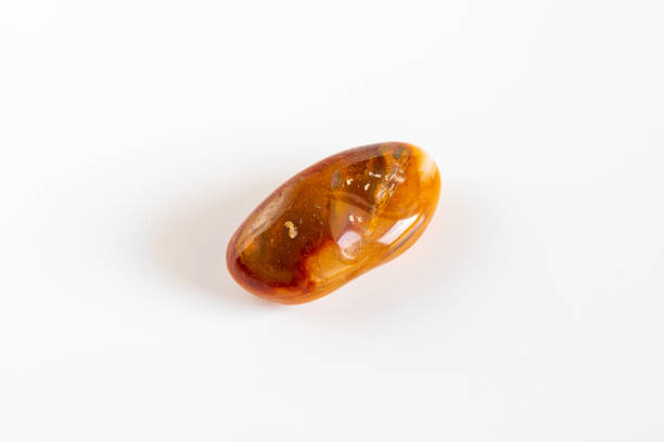 istock Macro mineral stone Carnelian on white background 1047731942