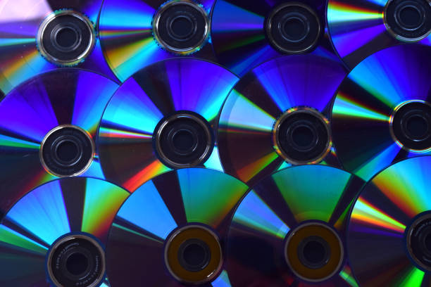 istock Background of illuminated DVD discs and CDs. 1047737502