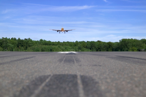 Jumbo jet coming into land, low perspective focus is on the plane foreground blurred.