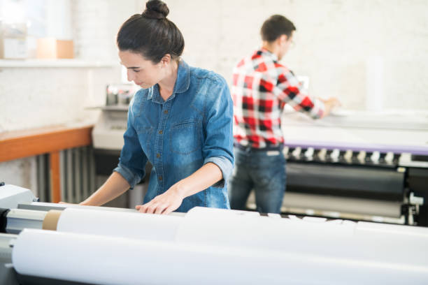 istock Concentrated woman working in printing office 1047738908