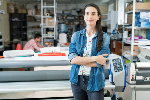 Confident female worker of printing house