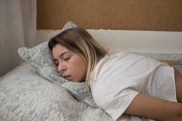istock young girl sleeping in bed 1047738974