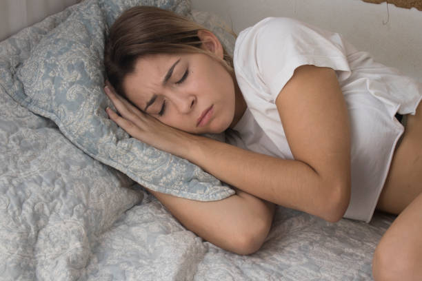 istock young girl sleeping in bed 1047741046