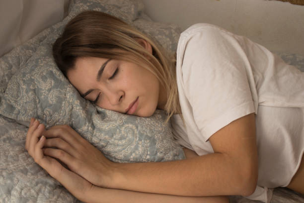 istock young girl sleeping in bed 1047741730