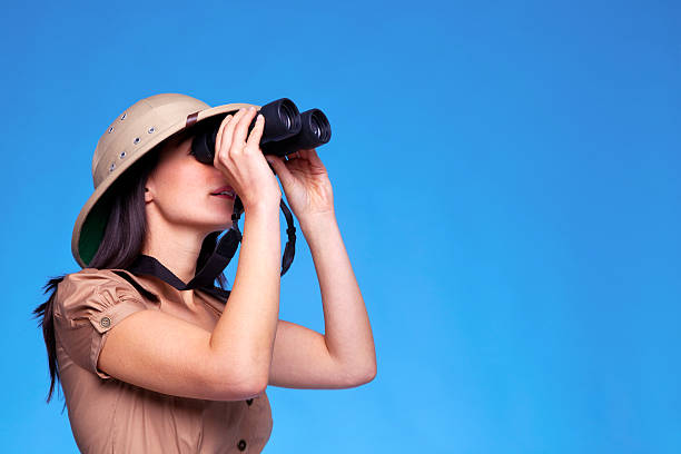 istock Woman in safari hat searching with binoculars 104774239
