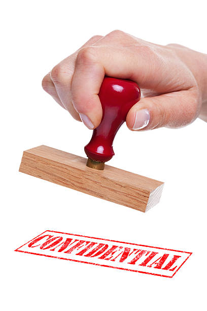 istock Hand holding a rubber stamp with the wordConfidential 104774246