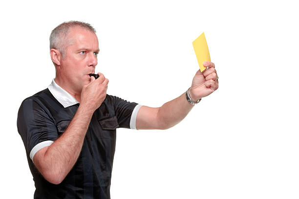 Referee showing the yellow card side profile stock photo
