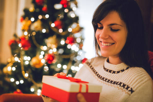 istock Woman with wrapped Christmas gift 1047743236