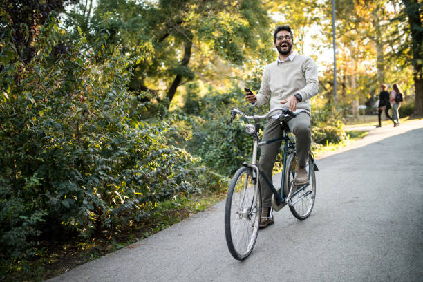 istock cyclist in park using his smartphone 1047744028
