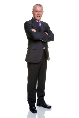 Mature businessman in his late 40s standing with arms folded looking to camera, isolated on a white background.