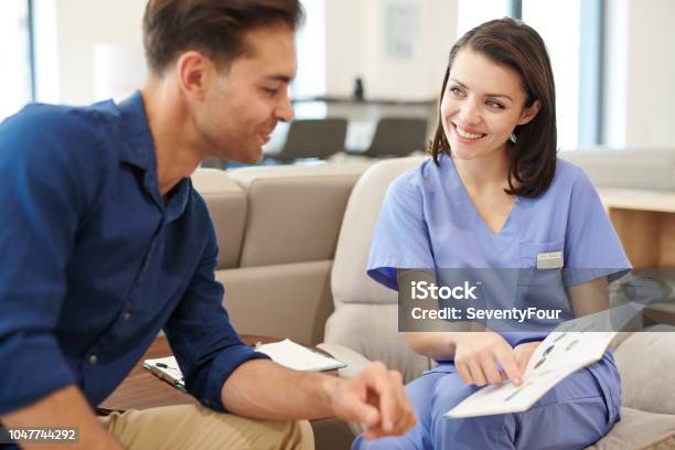 Nurse Talking To Patient Stock Photo - Download Image Now - Patient, Teaching, Brochure