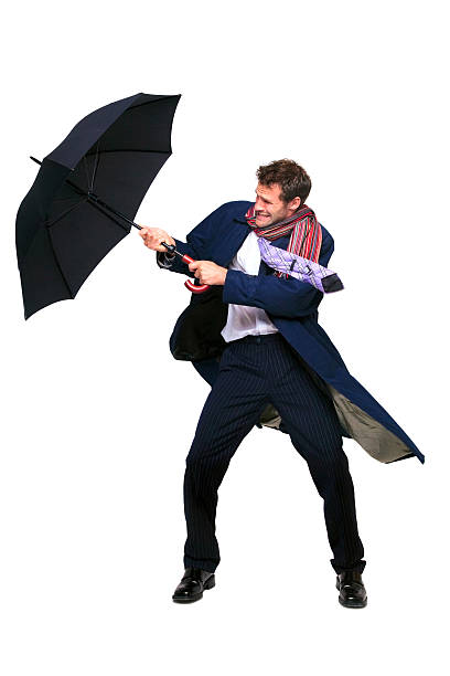 istock Businessman struggling with umbrella 104774511