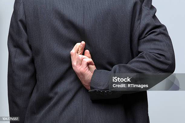 Businessman Fingers Crossed Behind His Back Stock Photo - Download Image Now - Adult, Back, Behind