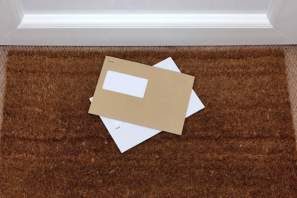 Envelopes on the doormat Two envelopes on a doormat, blank window to add your own name and address details. junk mail photos stock pictures, royalty-free photos & images