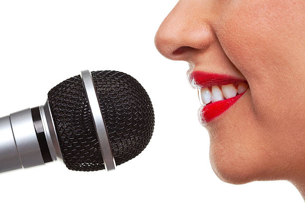 Close-up of red female lips near microphone
