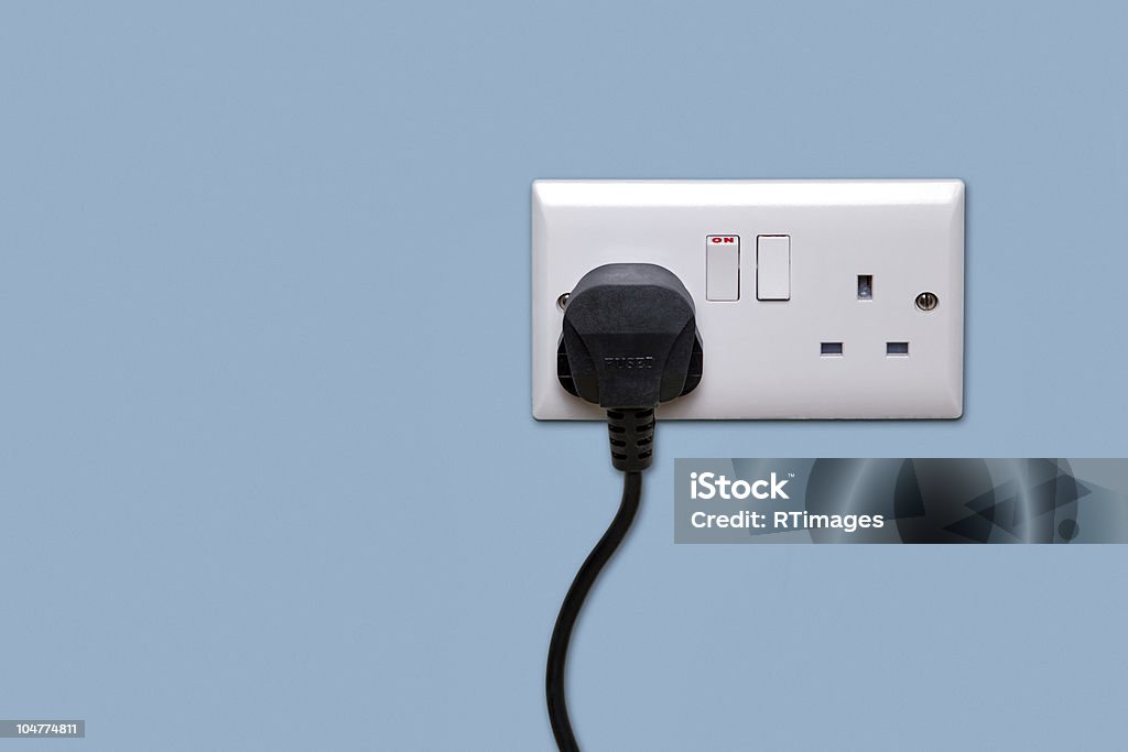 Double power socket and single plug switched on Double electrical power socket and single plug switched on, blue background. Electric Plug Stock Photo