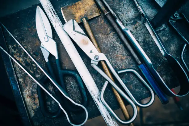 Glassblowing tools table background : forceps, tweezers, scissors , blowing pipes.