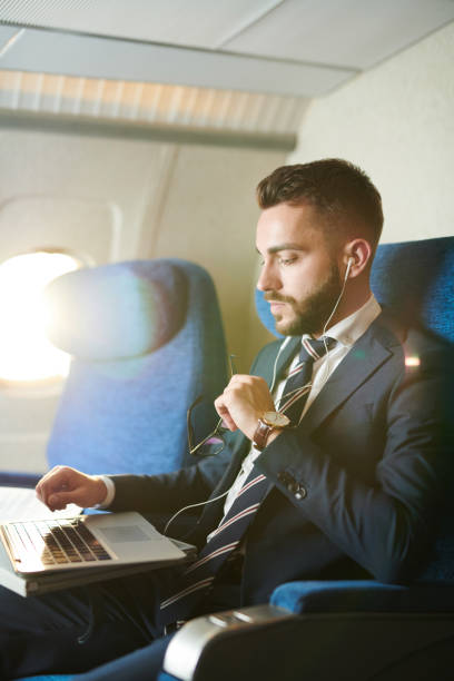 istock Handsome Businessman in Plane 1047752738