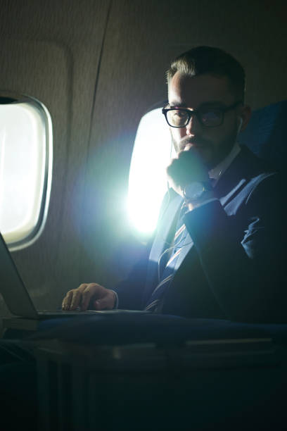 istock Pensive Businessman in Plane 1047752812
