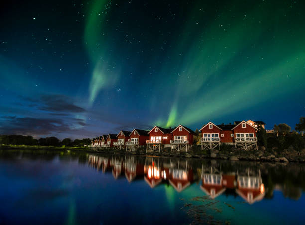 Northern lights over red huts in northern Norway.