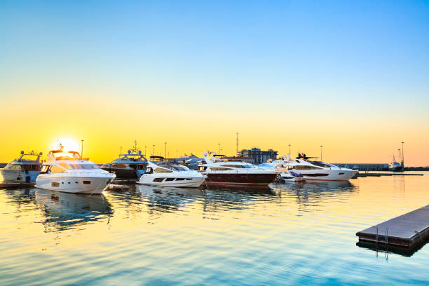 istock Yachts moored in seaport at sunset. 1047757302