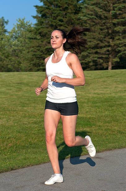 istock Attractive physically fit young woman jogging 104775731