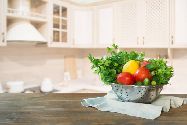 istock Blurred background. Modern kitchen with empty wooden tabletop, space for you and display your products. 1047757454