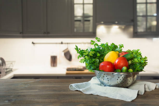 istock Blurred background. Modern kitchen with empty wooden tabletop, space for you and display your products. 1047757462
