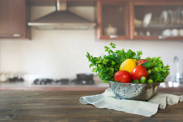 istock Blurred background. Modern kitchen with empty wooden tabletop, space for you and display your products. 1047757468